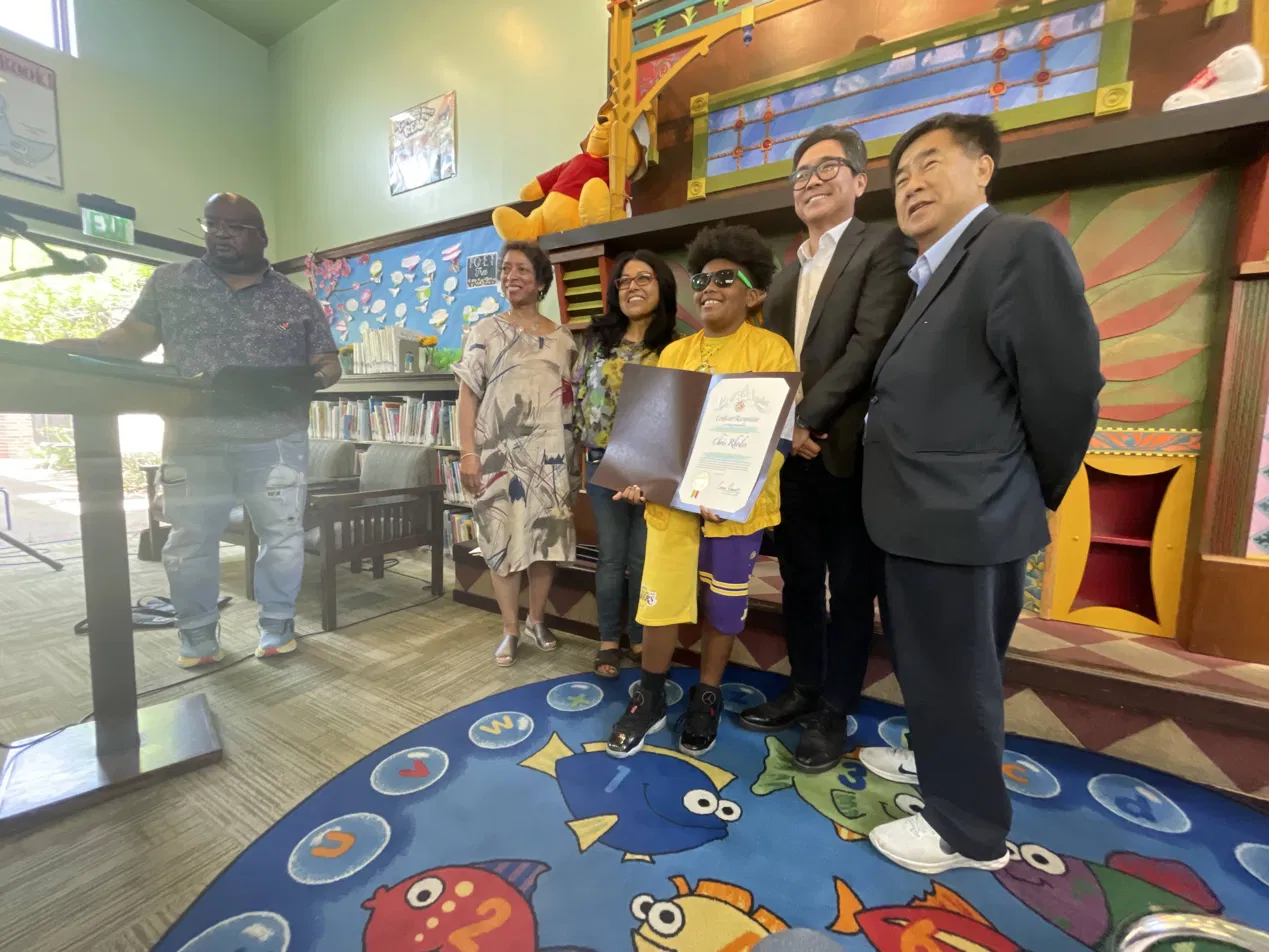 A young honoree receiving a poetry award